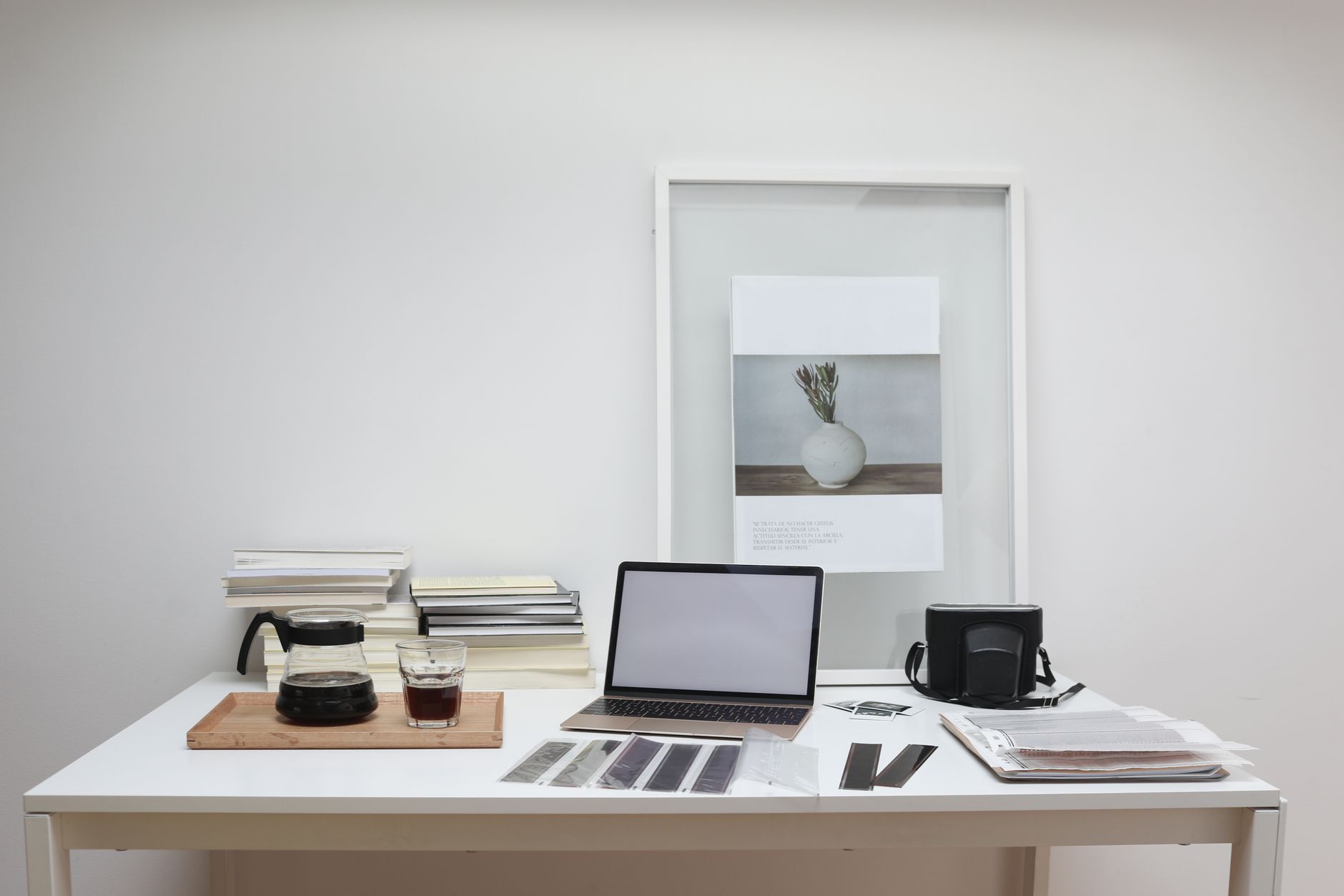 Writer at desk reviewing travel prints